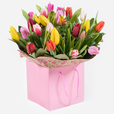 Tulip Temptations - A cheerful tulip posy hand-tied featuring a variety of beautiful colours carefully selected by the local florist. Hand-delivered in a gift bag or box.